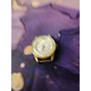 Vintage Manson Gold-Tone Watch with White Enamel Finish and Ornate Leaf Detail